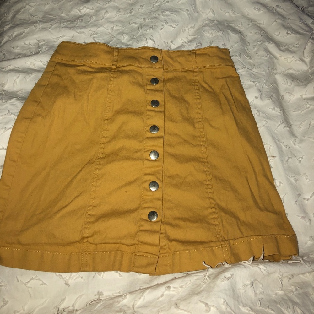 woman’s mustard yellow button down skirt